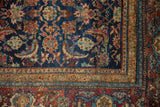 Antique Malayer rug corner detail, intricate herati and mahi motifs in indigo, red, and bronze.