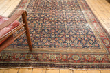 Antique Malayer carpet corner, Herati motif in indigo, wine red, ivory, with distressed texture.