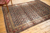 Distressed antique Malayer carpet, showcasing herati and mahi motifs in indigo, wine, ivory.