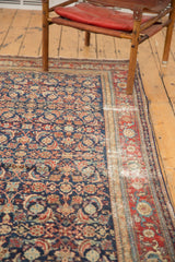 Distressed antique Malayer carpet, revealing threadbare Herati motif in indigo, red, and ivory.