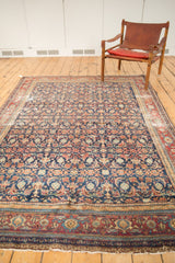 Distressed antique Malayer carpet with intricate Herati and mahi motifs.