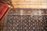 Antique distressed Malayer carpet with threadbare red border and deep blue Herati pattern.