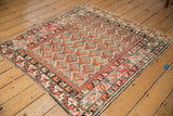 Antique Hamadan rug: checker motif field, stylized border, tangerine, red, ivory hues, low pile.