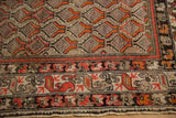 Antique Hamadan rug's intricate border with red, tangerine, chocolate shrub motifs and checker field.