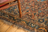 Madder root red field, navy blue border, and traditional fringe of antique Persian Qashqai rug.