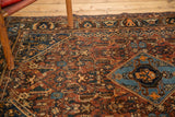 Antique Qashqai rug's sky blue diamond medallion with herati field in madder red, navy.