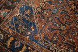 Antique Qashqai rug detail: blue medallion element surrounded by copper herati motifs.
