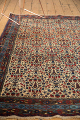 Traditional border and trellis motif on the vintage Kurdish Bijar rug with light fringe.