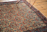 Allover cypress tree trellis motif with blossoming plants on a vintage Bijar rug.