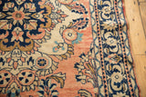 Detail of vintage Lilihan rug with stylized Rococo floral motifs and ornamented border.