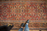 Antique Kurdish Bijar rug, Herati motif, oblong diamond medallions. Madder red, charcoal, blue hues, even wear.
