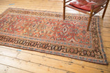 Antique Kurdish Bijar rug's herati motif field in madder root red and intricate dark border.