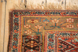 Secured fringe and geometric herati borders on an antique Kurdish Bijar rug, displaying etched darker shades.