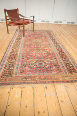 Angled view of Antique Kurdish Bijar rug, showing intricate herati motif, madder red, and subtle patina.