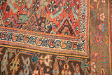 Antique Kurdish Bijar rug corner showcasing herati motif, madder root red, and pile etching.