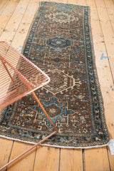 Distressed vintage Karaja runner detail: geometric hook and latch motifs in brown, blue, ivory.