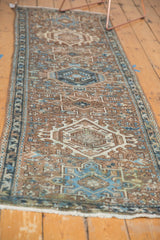 Distressed Karaja runner showcasing geometric medallions and hook and latch motif in brown and sky blue.
