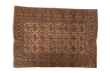 Vintage distressed Afghan rug with allover camel gold and chocolate brown gul motif.