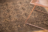 Distressed vintage Afghan rug featuring camel gold gul motifs and detailed borders.