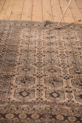 Distressed pale camel gold and chocolate brown gul motifs with a geometric border.