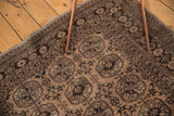 Distressed texture of camel gold and chocolate brown gul motif corner.