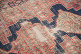 Distressed vintage Senneh rug detail, showing worn pile with cherry red, indigo blue, and foundation.