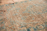 Vintage distressed Heriz rug with curvilinear motifs, pale blue and camel tones, and even wear.