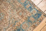 Distressed vintage Heriz rug showing faint foundation through even wear, curvilinear blue border.