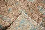 Distressed camel and blue Heriz rug, showing worn pile exposing woven foundation.