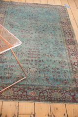 Antique Kerman rug's distressed aqua field with delicate scrolling vinery and faded burgundy border.