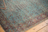 Antique Kerman rug: faded aqua field of delicate vinery meets a wine red and gold floral border.