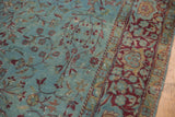 Distressed aqua blue, burgundy, and gold scrolling vinery of an antique Kerman rug.