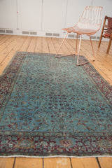 Antique Kerman rug's distressed aqua field, showing faint foundation and elegant burgundy border.