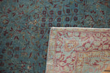 Antique distressed Kerman rug showing worn aqua pile and a contrasting patterned reverse side.