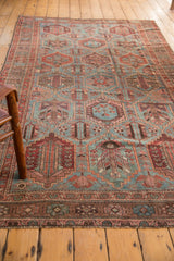 Distressed Baktiari carpet with multi-paneled geometric seasons motif in dusty blue and madder red.