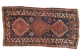 Antique Kazak runner with triple madder root red hook and latch medallions on a navy field.