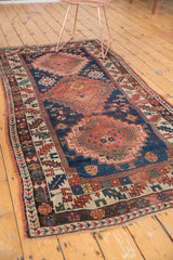 Antique Kazak runner with geometric hook and latch medallion, palmettes, serpents, and visible wear.