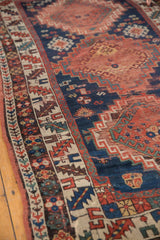 Antique Kazak runner's geometric medallion with hook and latch motifs, navy blue and madder red patina.