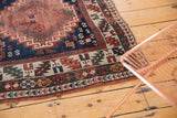 Antique Caucasian Kazak runner corner with geometric borders, hook and latch motifs, and mostly even wear.