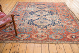 Antique Caucasian Soumac fragment rug with geometric medallion, dense tribal field, red, blue, ivory.