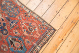 Antique Soumac fragment with cherry red and navy blue geometric patterns.