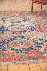 Visible fragmented edge and worn geometric red and navy patterns on antique Caucasian Soumac.