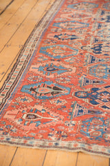 Antique Caucasian Soumac fragment detailing brick red field with dense blue geometric and stylized motifs.