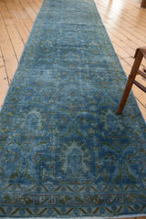 Distressed Hamadan runner showcases faded blue overdye, low pile, and sprawling palmette motifs.