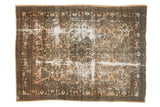 Decorative distressed Hamadan carpet with ornate floral motifs, light camel field, and visible foundation wear.