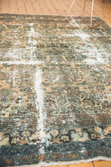 Distressed vintage Hamadan carpet detail with exposed foundation, floral patterns, and seafoam blue accents.