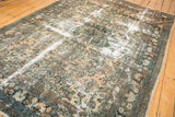 Distressed Hamadan rug, light camel field, seafoam and brown floral patterns, exposed foundation.