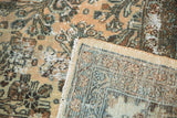 Distressed Hamadan pile showing wear, faded camel floral pattern, woven reverse, and fringe.