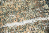 Close-up of distressed Hamadan carpet's worn pile, revealing exposed white foundation.