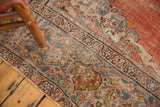Antique Mahal carpet corner detail: worn curvilinear spandrel in madder red, sky blue.